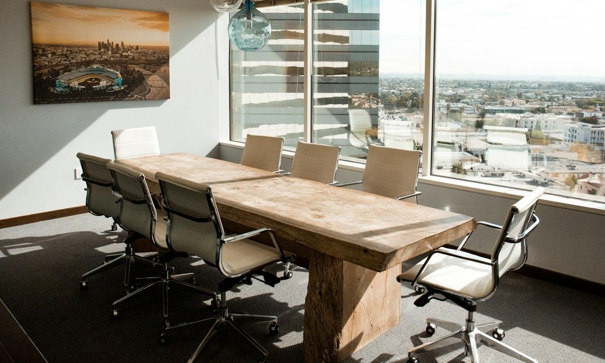 Meeting room with a timber table and a city view