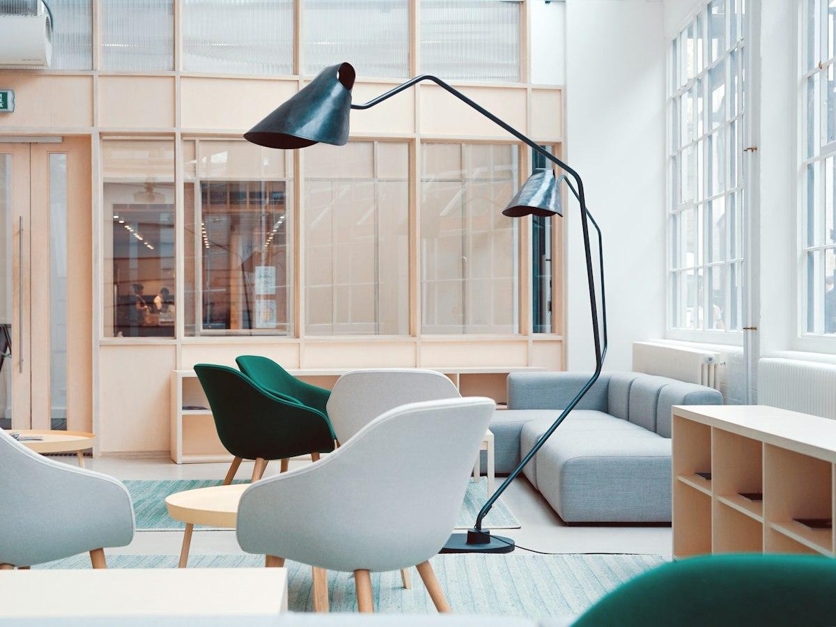 Bright lounge with armchairs and tall windows