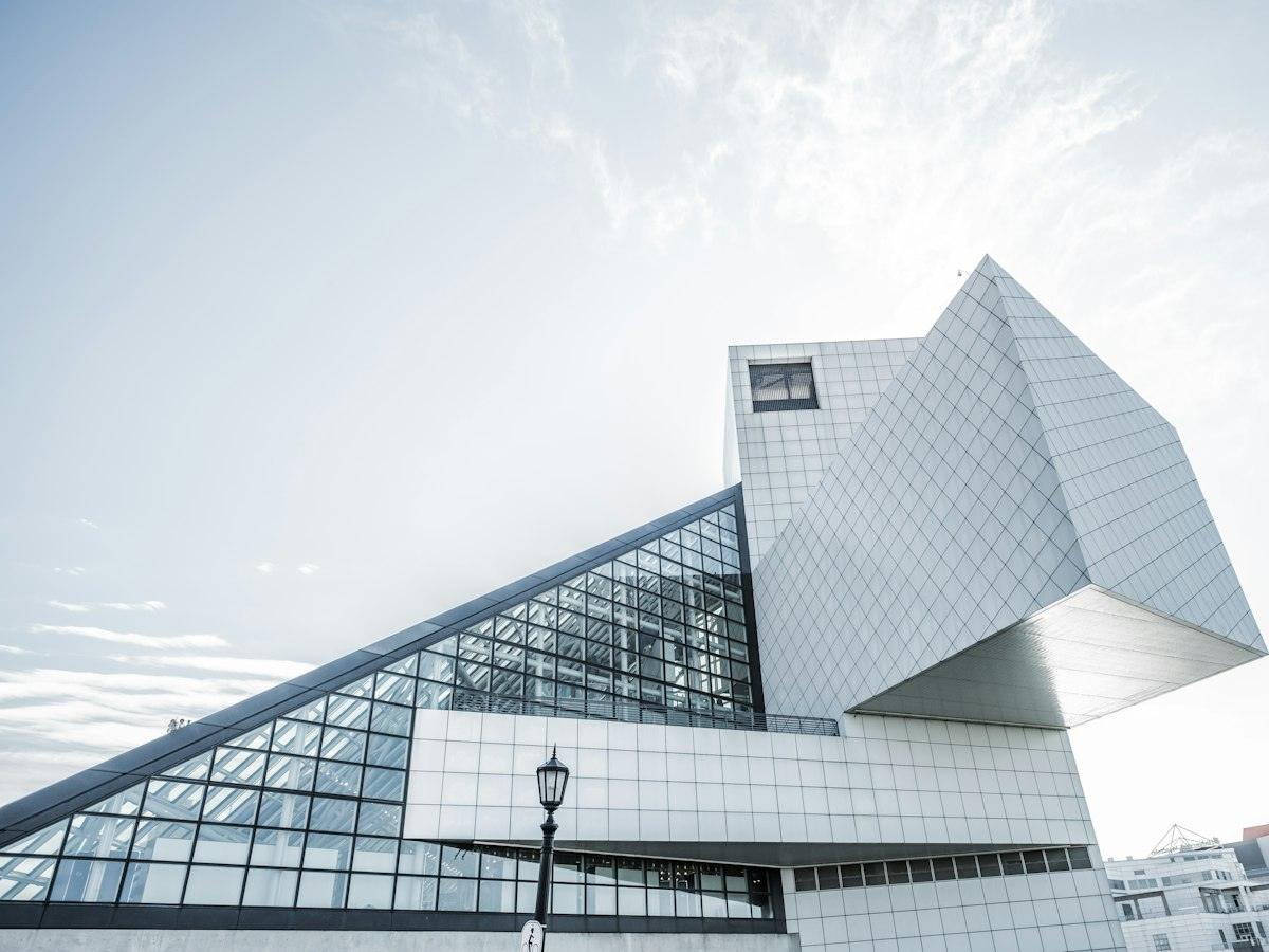 Sculptural white building with angled glass and panels