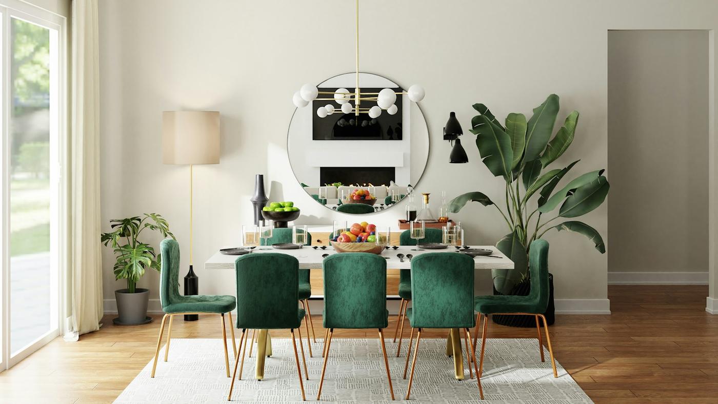 Dining room with green velvet chairs and a round mirror