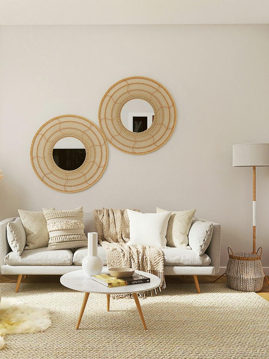 Light living room with a linen sofa and two rattan mirrors